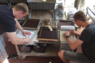 Two students shuttering the relief panels in the concrete laboratory