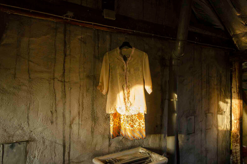 Blouse with skirt hanging in a dilapidated hut