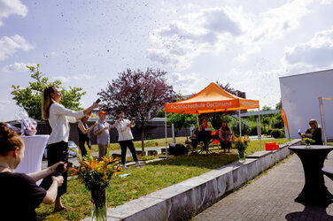 several people set off confetti cannons to celebrate completed doctorates