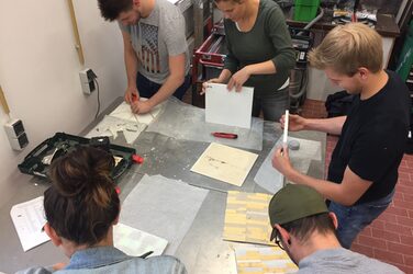 5 Students stripping the relief panels in the concrete laboratory