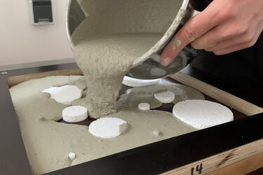 Pouring the slab mold with concrete from the bucket