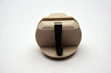 Design 9: circular model in beige made of generatively produced elements with a hook against a white background