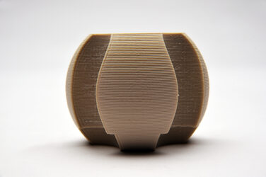 Design 9: Circular model in beige made of generatively produced elements against a white background