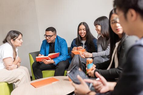 Group of international students sitting in a corner and chatting.