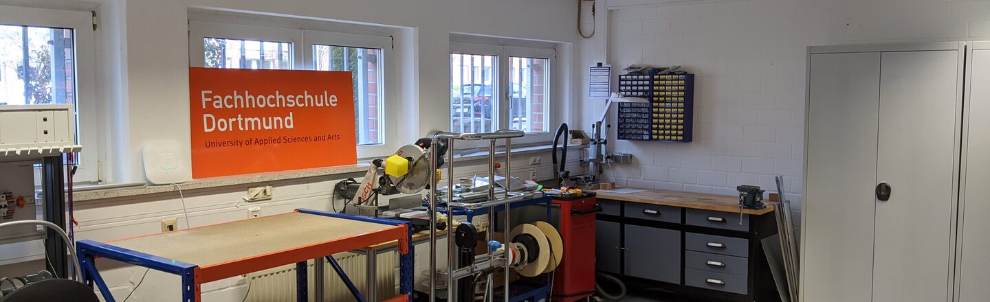 Workshop space with cupboards, shelves and workbenches