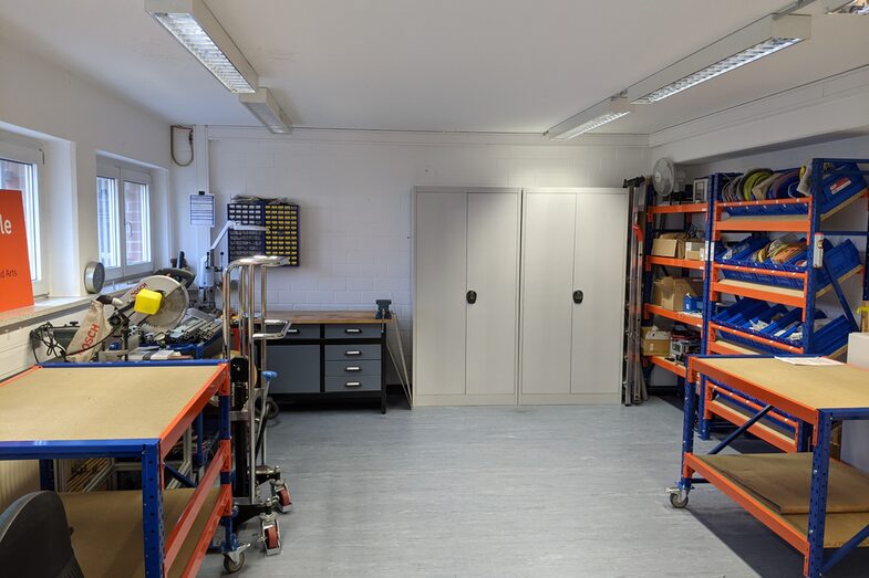 Workshop space with cupboards, shelves and workbenches