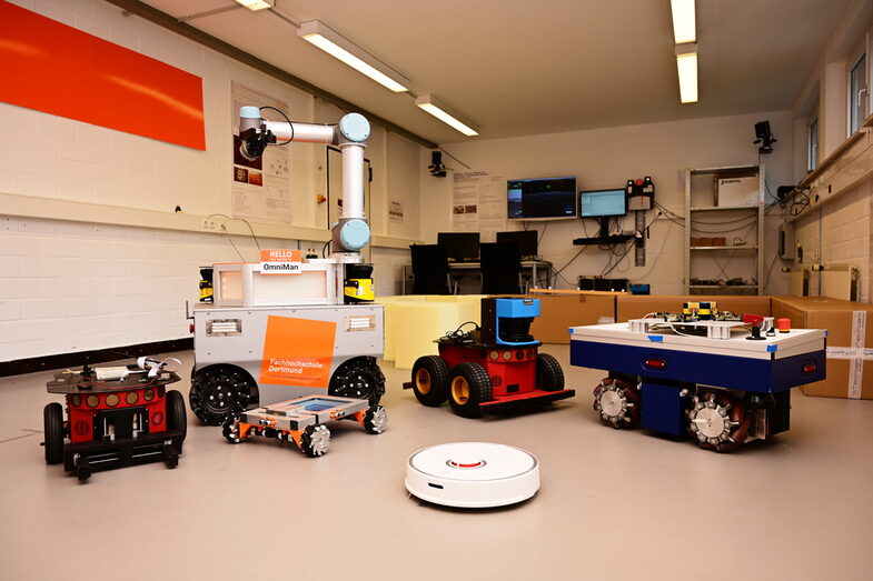 Arrangement of six mobile robots with a workstation in the robotics lab__Arrangement of six mobile robots with a workstation in the robotics lab.