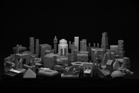 Black and white general view of the filigree concrete sculptures as a result of the "miniature architecture" exercise. The composition of the sculptures is reminiscent of a city. The individual sculptures depict buildings and landmarks.