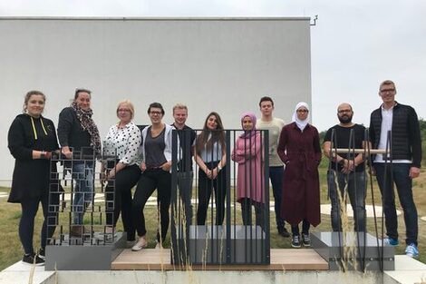 Group photo of the participating students on campus with three railing prototypes.