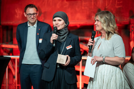 Several people with a microphone.