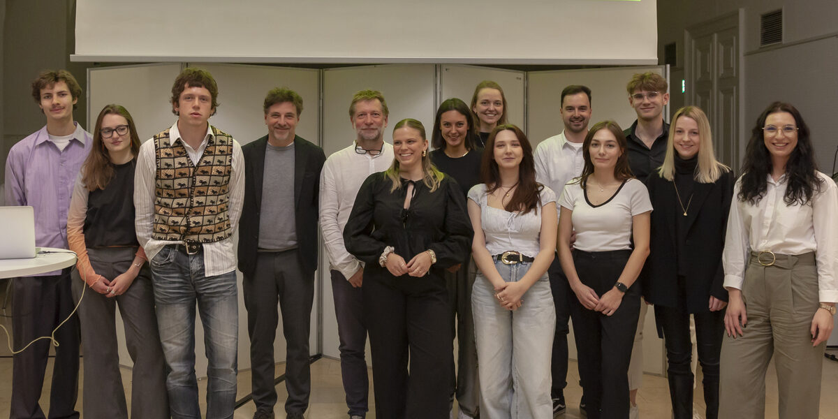 Winners of the Architects Collective Student Award for Healthcare Architecture on stage in front of a screen.