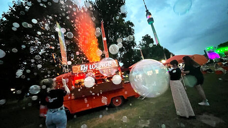 The FH vintage car with an illuminated fountain of fog and lots of soap bubbles.