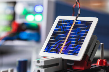 Close-up of a square solar cell with outgoing cables.